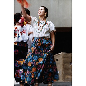 Woman in traditional costume performing on the outdoor stage at Festival Betances.
