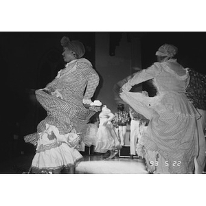 Dancers performing a traditional Puerto Rican dance during a Café Teatro performance.
