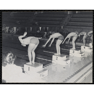 Five swimmers prepare to dive off the starting blocks at the Boys' Clubs of America New England Regional Swimming Championships at Harvard
