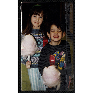 A girl and a boy with cotton candy posing together at a joint Charlestown Boys and Girls Club and Charlestown Against Drugs (CHAD) event
