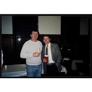 Two Bunker Hillbilly alumni share a drink at a reunion event