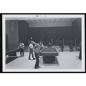 Youth playing pool in the game room