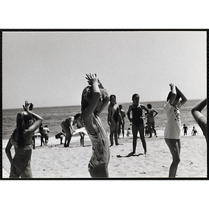 A group of girls dance on a beach