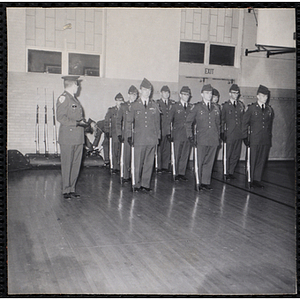 Boston University Company B-12 cadets stand with their rifles at their sides at the Charles Hayden Clubhouse on Physical Fitness Day