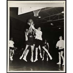 Four players leap for a rebound during a basketball game