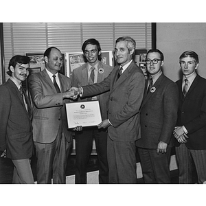 Dean Melvin Mark and the Clean Air Car Team students receive a certificate of appreciation