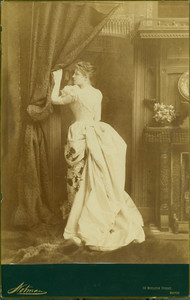 Full-length portrait of Lillie Langtry, standing, left profile, holding on to a curtain, Notman, 99 Boylston Street, Boston, Mass., 1886-1887