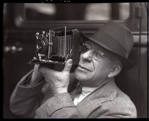 Sam Connor and Bob Emery: man taking a picture with a Zeiss Ikon Super Ikonta camera