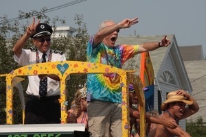 Paraders waving to the crowd from atop a float : Provincetown Carnival parade