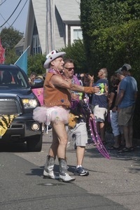 Parade marcher in cowboy outfit and tutu : Provincetown Carnival parade