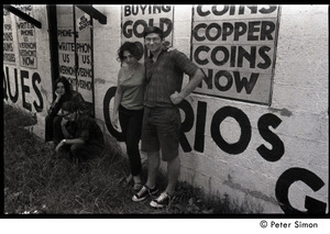 Communards standing in front of advertising signs at a curios store: Verandah Porche, Michael Gies, Lissa Matross, and Harvey Wasserman (l. to r.)