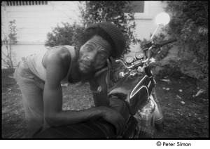 Alvin 'Seeco' Patterson leaning over a motorcycle