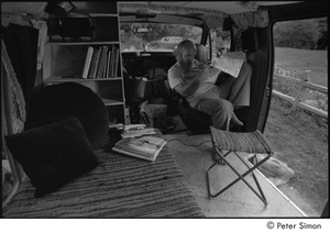 Ram Dass in his van: Ram Dass studying a map