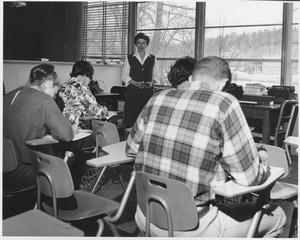 Marjorie Rodgers standing in classroom with unidentified students