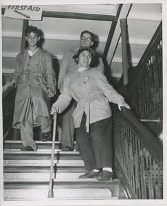 Woman with cane going down the stairs