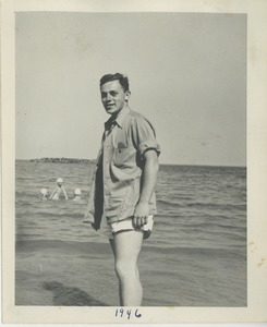 Unidentified young man standing in the ocean