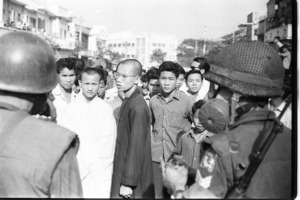 Buddhist monks from the Vien Hoa Dao Institute march while soldiers block the road; Saigon.