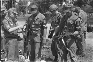 U.S. troops inspecting Chinese weapons captured from the Vietcong at Bau Bang.