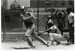 Mayor Raymond L. Flynn playing baseball in Boston with a group of unidentified men