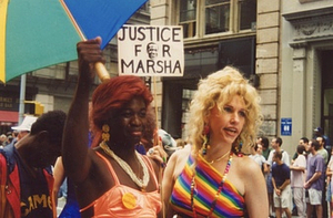 A Photograph of Cocoa Rodriguez and Queen Allyson Posing with a "Justice for Marsha" Sign
