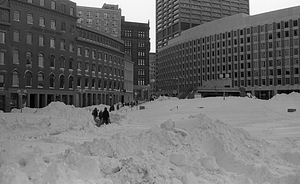 Snow piles and pedestrians in Boston City Hall Plaza and Cambridge Street