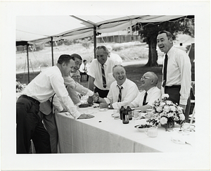 Mayor John F. Collins greeting individuals at an outdoor luncheon