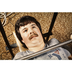 Man lifting a barbell in a gym