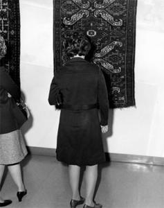 Woman viewing Carpet at Exhibition of "Ancient & Oriental Rugs"