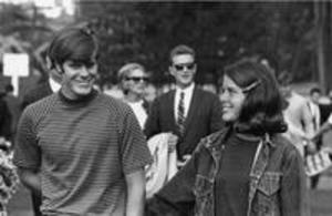 A young man and woman smile at each other, 1969