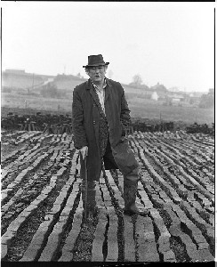 Seamus Heaney at a turf bog in Bellaghy wearing his father's coat, hat and walking stick and additional shots in the Bellaghy bog
