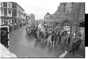 Funeral of RUC police officer Martin Vance, murdered by the PIRA, Downpatrick. Various shots of the mourners. Some as they make their way through Downpatrick to St. Patrick's Catholic Church, including senior RUC officers and the RUC Band
