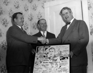 Two men posing with Thomas P. O'Neill and cartoon of Thomas P. O'Neill drawn by Joe Beesan, one man shaking hands with Thomas P. O'Neill