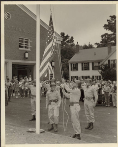 Troops from the Nike Station in Reading, MA raise the American flag at the dedication of Fire Station #2