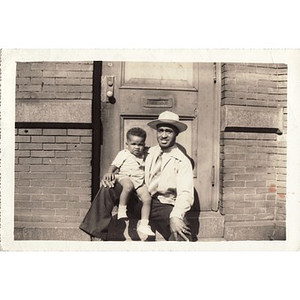 Laymon Hunter sits with a small child on the steps