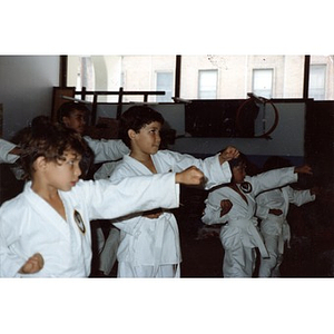 Classroom of young Latino boys performing a karate demonstration at the Festival Betances, Boston, 1986