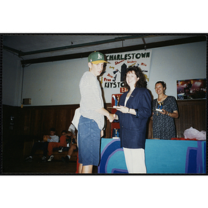 A woman shakes hands with an award recipient at a Boys & Girls Club Awards Night