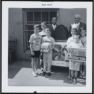 Six winners of the Boys' Club Freckle King Contest and two judges posing with the freckle meter