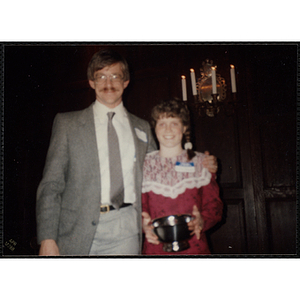 Julie Treanor holds her trophy while posing with Jerry Steimel, Charlestown Boys and Girls Club Director, at the "Recognition Dinner at Harvard Club"