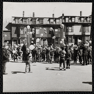 Boys gather for a ballon raising at a carnival