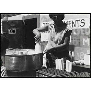 A woman makes cotton canday at a carnival