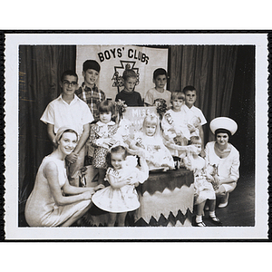 Group portrait of the Little Sister Contest winners with their brothers and two judges