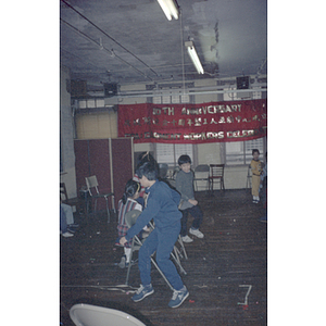 Children play musical chairs at a celebration