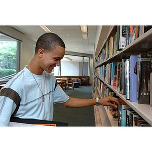 Odalis David Polanco looks at a shelf of books during a scavenger hunt