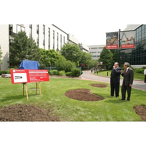 President Freeland and Richard Egan look at the site of the future Veterans Memorial during the groundbreaking ceremony