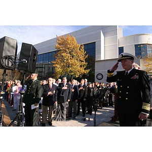 Mark Fitzgerald and the rest of the audience hold hands over their hearts at the Veterans Memorial dedication