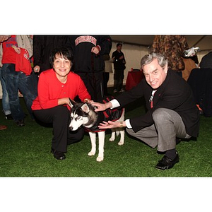 President Freeland and his wife Maria pose with King Husky at the Homecoming game