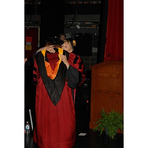 Dean Carole Kenner, right, and Patricia Kiladis, a professor, from the School of Nursing hug during convocation