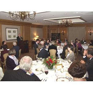 Barry Karger, at podium, addressing audience at gala dinner for John Hatsopoulos