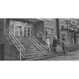 Law students walk up the steps to the Law School building