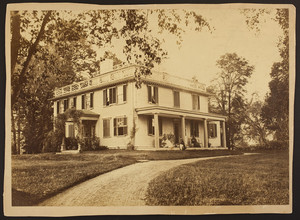 Exterior view of the Quincy House with family seated on porch